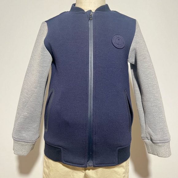 A boys Jacadi Paris zip-up cardigan.